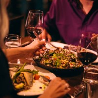 couple eating quinoa salad and healthy dinner at restaurant - food stock pictures, royalty-free photos & images