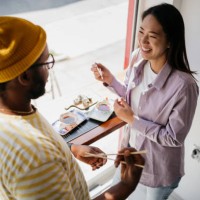 couple eating sushi - junk food stock pictures, royalty-free photos & images