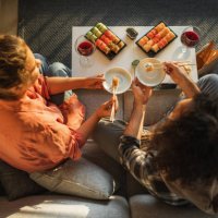 couple enjoying assorted sushi home delivery. - junk food stock pictures, royalty-free photos & images
