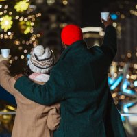 couple enjoying outdoor winter festival at night with colorful lights - concert stock pictures, royalty-free photos & images