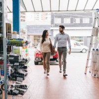 couple entering a construction material store - home decoration stock pictures, royalty-free photos & images