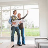 couple holding building plans and discussing remodel - home decoration stock pictures, royalty-free photos & images