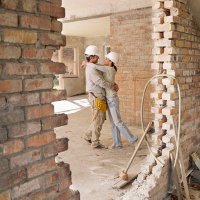 couple hugging in house under construction - home decoration stock pictures, royalty-free photos & images