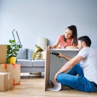 couple in new apartment assembling furniture together - home decoration stock pictures, royalty-free photos & images