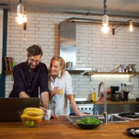 couple in the kitchen using laptop - home decoration stock pictures, royalty-free photos & images
