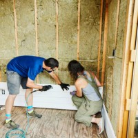 couple installing siding during home improvement project - home decoration stock pictures, royalty-free photos & images