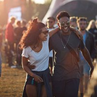 couple laughing together at big festival - concert stock pictures, royalty-free photos & images