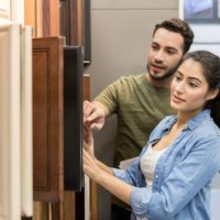 couple look at cabinet samples in hardware store - home decoration stock pictures, royalty-free photos & images
