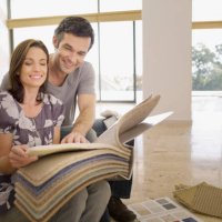couple looking at carpet samples in empty house - home decoration stock pictures, royalty-free photos & images