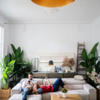 couple lying on couch, using heir smartphones - home decoration stock pictures, royalty-free photos & images