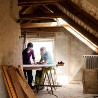 couple making plans to renovate old attic - home decoration stock pictures, royalty-free photos & images
