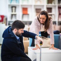 couple measuring in furniture shop - home decoration stock pictures, royalty-free photos & images