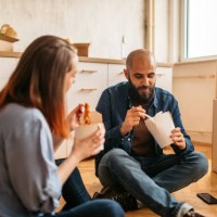 couple moving into new home enjoying takeaway food - junk food stock pictures, royalty-free photos & images