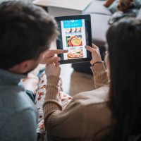 couple ordering food online at home. - food stock pictures, royalty-free photos & images