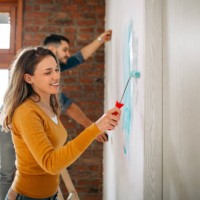 couple painting home walls together - home decoration stock pictures, royalty-free photos & images