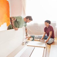 couple positioning planks during home renovation - home decoration stock pictures, royalty-free photos & images