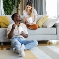 couple relaxing at home on the weekend - junk food stock pictures, royalty-free photos & images