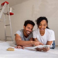 couple remodeling their house and choosing a color for the walls using a palette - home decoration stock pictures, royalty-free photos & images