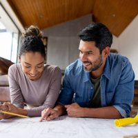 couple remodeling their house and looking at blueprints - home decoration stock pictures, royalty-free photos & images