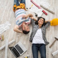 couple renovating and resting on floor - home decoration stock pictures, royalty-free photos & images