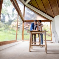 couple renovating their house and looking at the blueprints - home decoration stock pictures, royalty-free photos & images