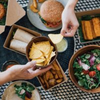 couple sharing takeaway food at home - junk food stock pictures, royalty-free photos & images