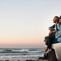 couple sitting on truck looking at ocean view - travel stock pictures, royalty-free photos & images