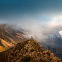 couple standing on top of a cliff looking at sunset, lanzarote, spain - travel stock pictures, royalty-free photos & images