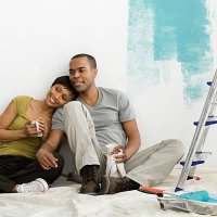 couple taking a break from painting - home decoration stock pictures, royalty-free photos & images