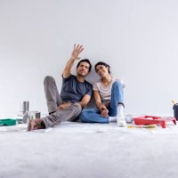 couple taking a break from painting their house - home decoration stock pictures, royalty-free photos & images