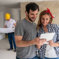 couple working on a housing project at their house - home decoration stock pictures, royalty-free photos & images