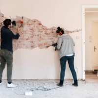 couple working on reconstruction of their apartment - home decoration stock pictures, royalty-free photos & images