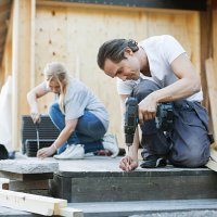 couple working outside house during home improvement - home decoration stock pictures, royalty-free photos & images