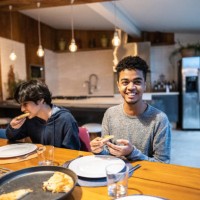 cousin having pizza together in family at home - junk food stock pictures, royalty-free photos & images