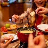 coworkers eating fondue - food stock pictures, royalty-free photos & images