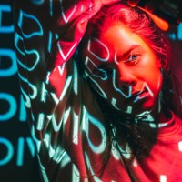 crimson red technological concept with a person lit with neon cyan projection - fashion stock pictures, royalty-free photos & images