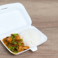 crispy pork with basil fried rice in foam box on wood background - junk food stock pictures, royalty-free photos & images