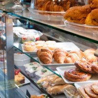 croissants, sandwiches and other pastries displayed in bakery for take away - junk food stock pictures, royalty-free photos & images