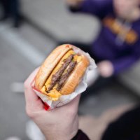 cropped hand of person holding burger,san francisco,california,united states,usa - junk food stock pictures, royalty-free photos & images