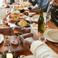 cropped hands of man cutting meat on dining table - food stock pictures, royalty-free photos & images