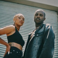 cropped portrait of a young couple standing together and posing on the street during the day - fashion stock pictures, royalty-free photos & images
