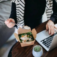 cropped shot of young asian woman eating takeaway meal, a fresh and healthy grilled chicken vegetable salad lunch box while working from home during lunch - junk food stock pictures, royalty-free photos & images