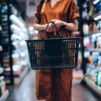 cropped shot of young woman carrying a shopping basket, standing along the product aisle, grocery shopping for daily necessities in supermarket - food stock pictures, royalty-free photos & images
