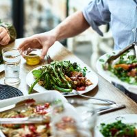 cropped view of table laid with crockery and fresh homemade vegetarian food - food stock pictures, royalty-free photos & images