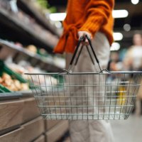 cropper shot of young woman carrying a shopping basket while shopping in supermarket - food stock pictures, royalty-free photos & images