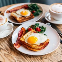croque madame sandwich with bacon served for breakfast in a restaurant, side view - food stock pictures, royalty-free photos & images