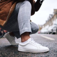 crouching man tying shoelaces on urban road - fashion stock pictures, royalty-free photos & images