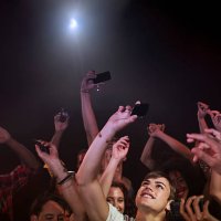 crowd in nightclub holding up cell phones - concert stock pictures, royalty-free photos & images