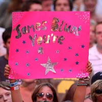 Crowd member holds a banner during the Live Earth concert at Wembley Stadium on July 7, 2007 in London, England. Live Earth is a 24-hour, 7-continent...
