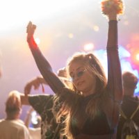 crowd of people attending a musical performance. punk girl dancing. bright light beams coming from the stage - concert stock pictures, royalty-free photos & images